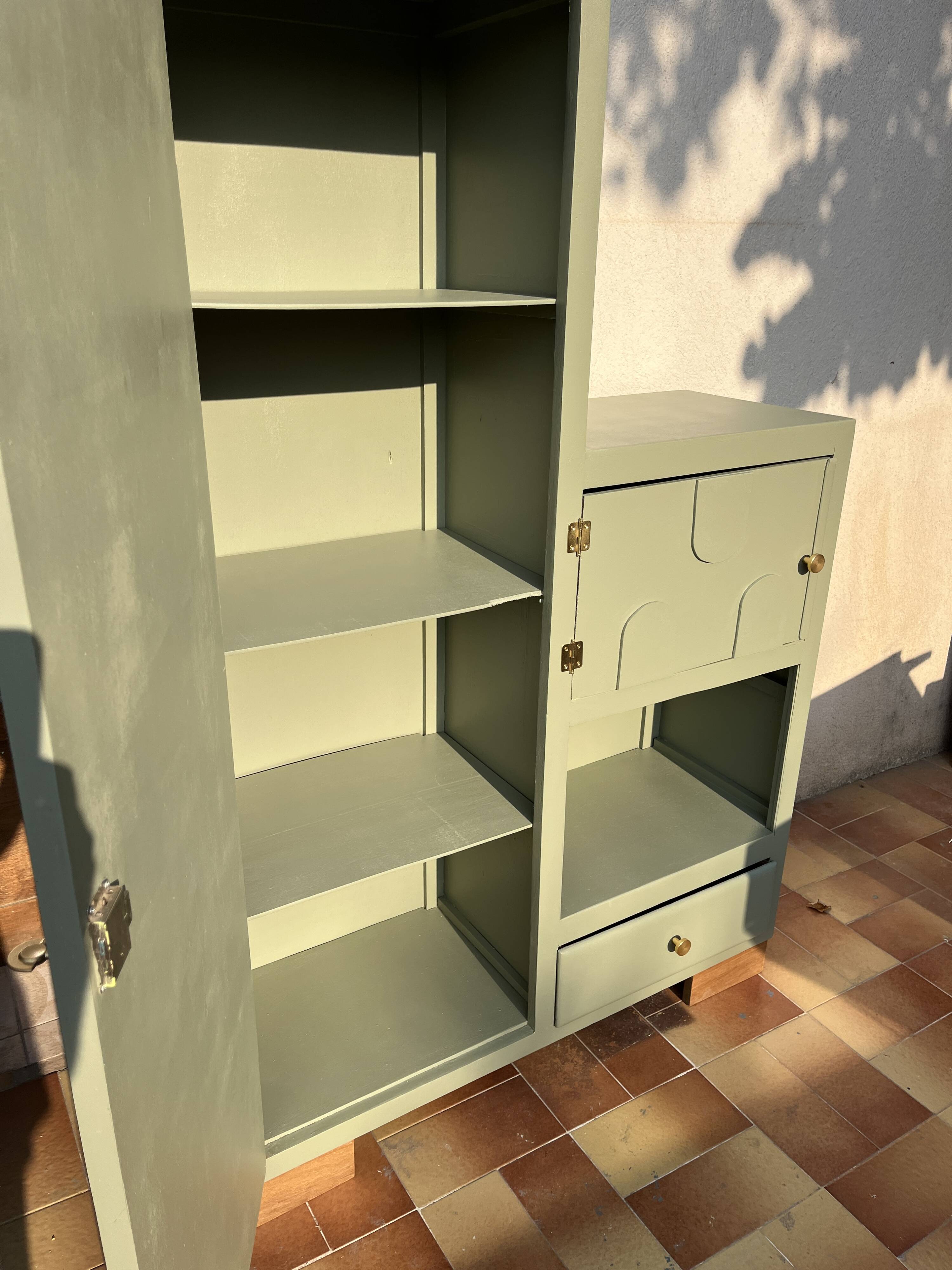 Asymmetrical vintage wardrobe painted in green.
