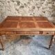 Antique French walnut table with six drawers, parquet top, early 20th century.