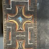 Indonesian construction element in carved wood with cross pattern in red, white geometric frieze