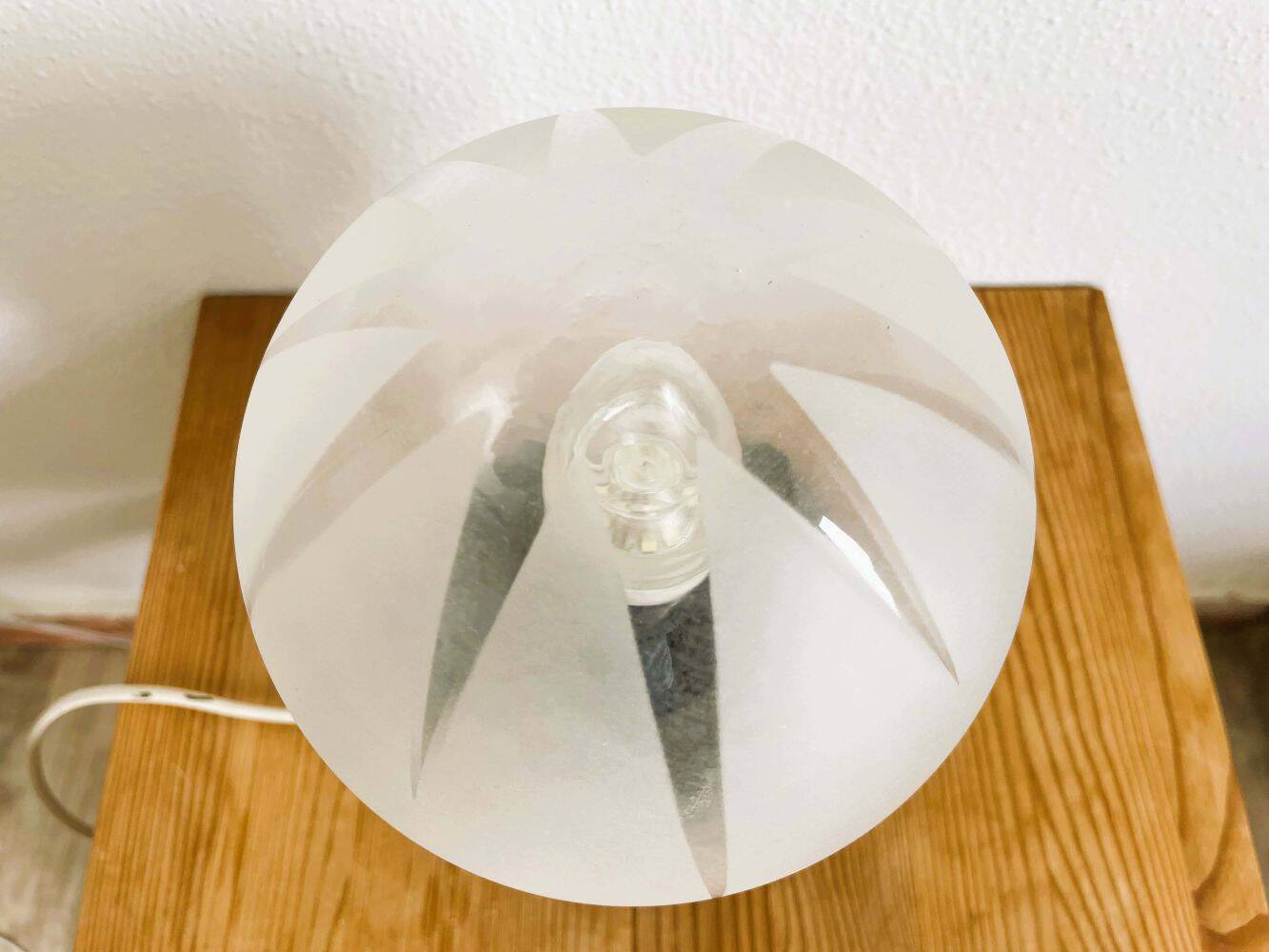 Small black wooden table lamp with frosted glass globe