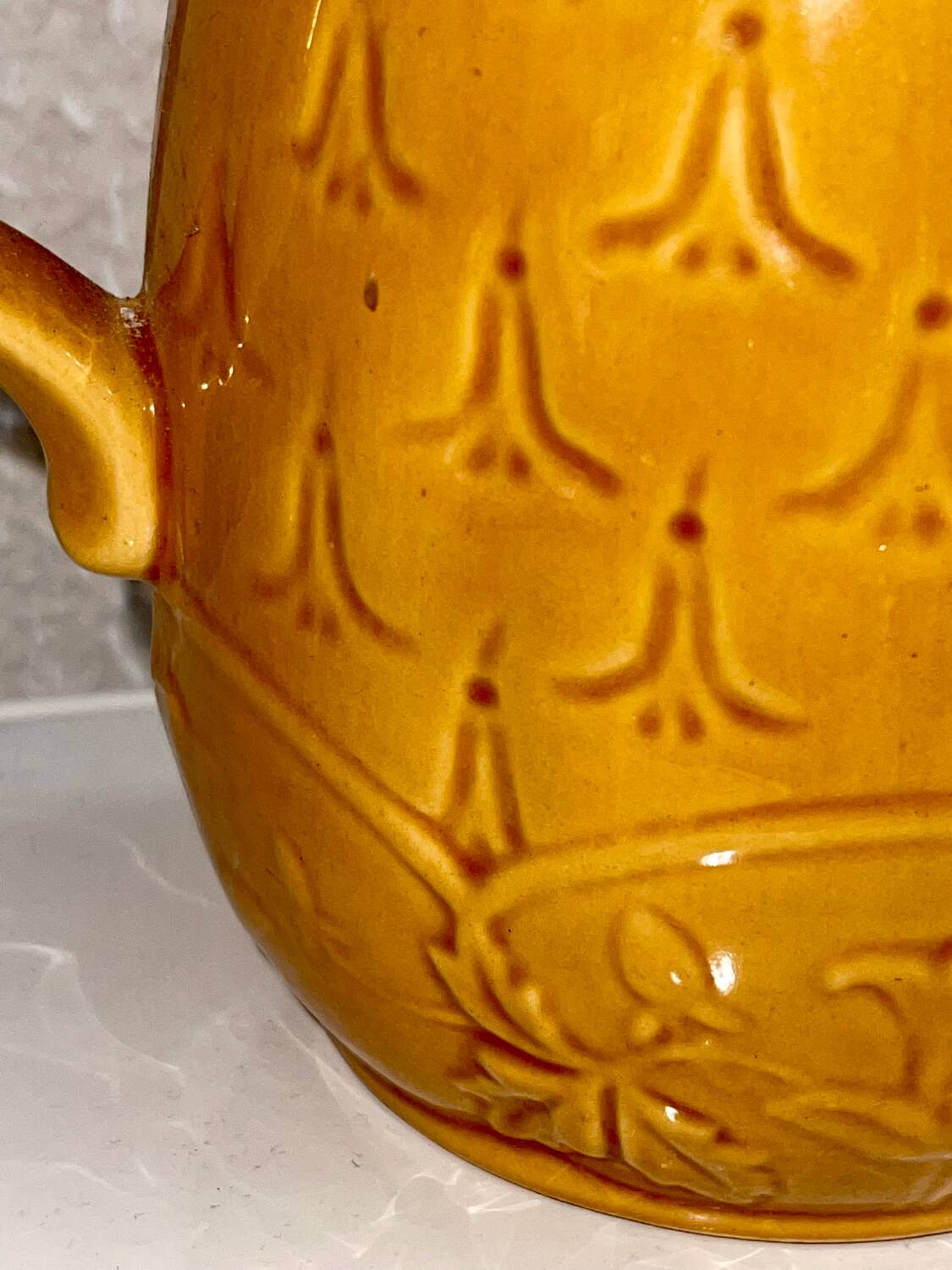 Antique pitcher with flower decoration