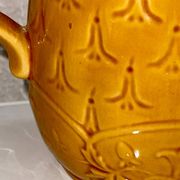 Antique pitcher with flower decoration