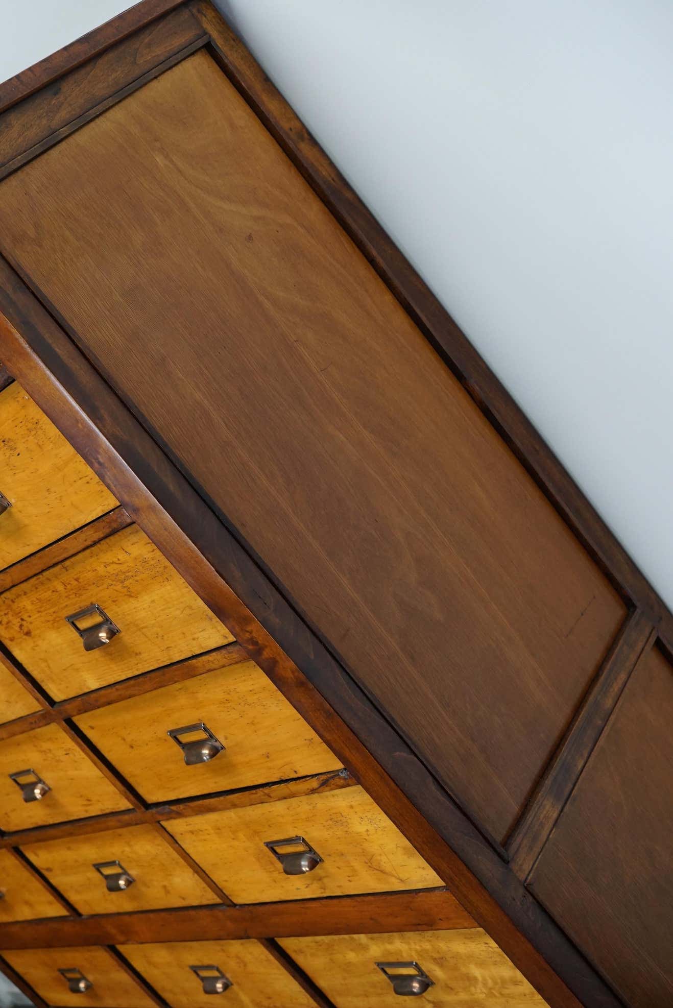 School cabinet bank of vintage Dutch drawers in mid-twentieth century pine