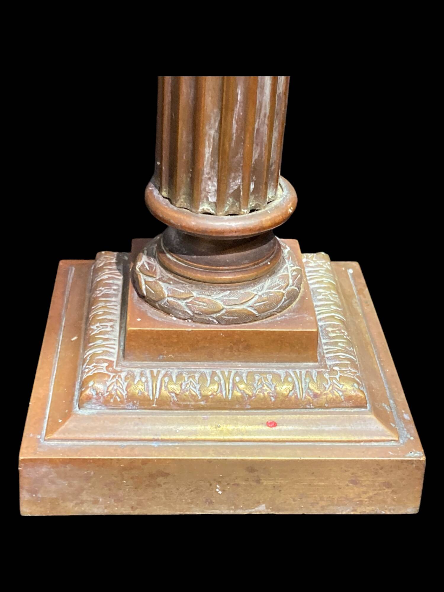 Bronze candle holder with floral motifs.