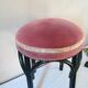 Black stool sitting in velvet rose