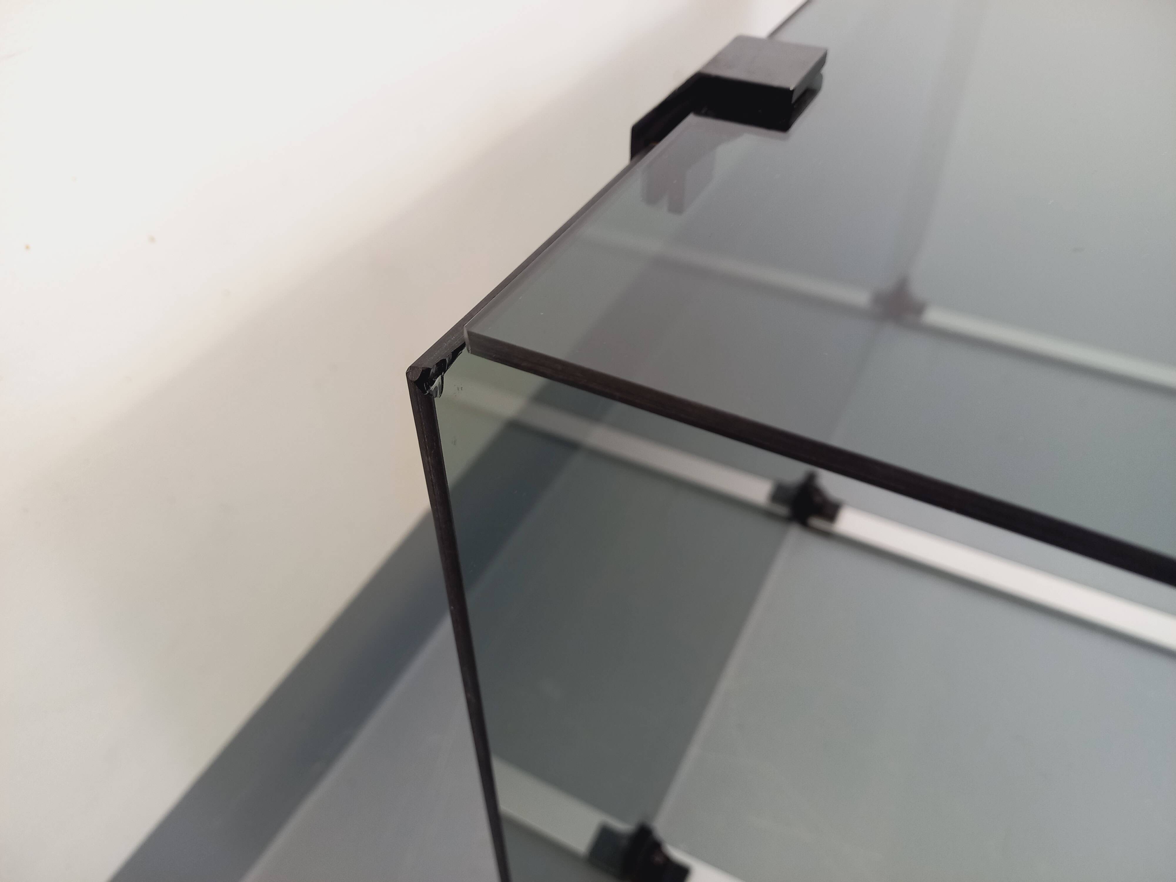 Vintage coffee table in smoked glass, black metal and cast aluminum