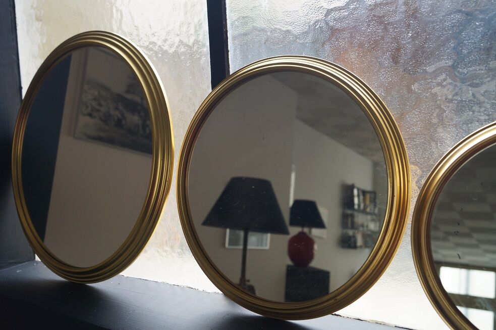 Suite of three brass mirrors