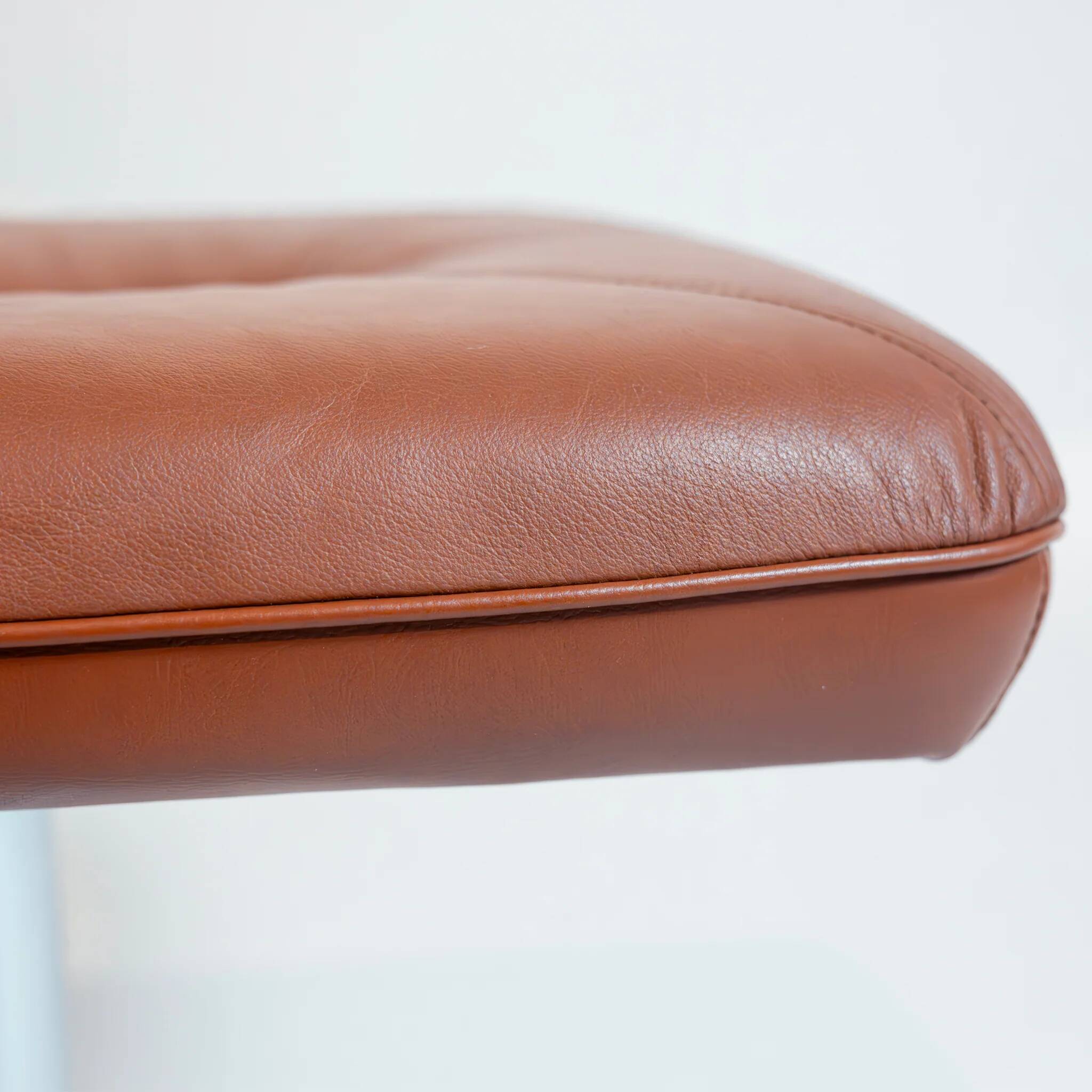 Vintage Scandinavian ottoman in brown leather with a chrome round base.