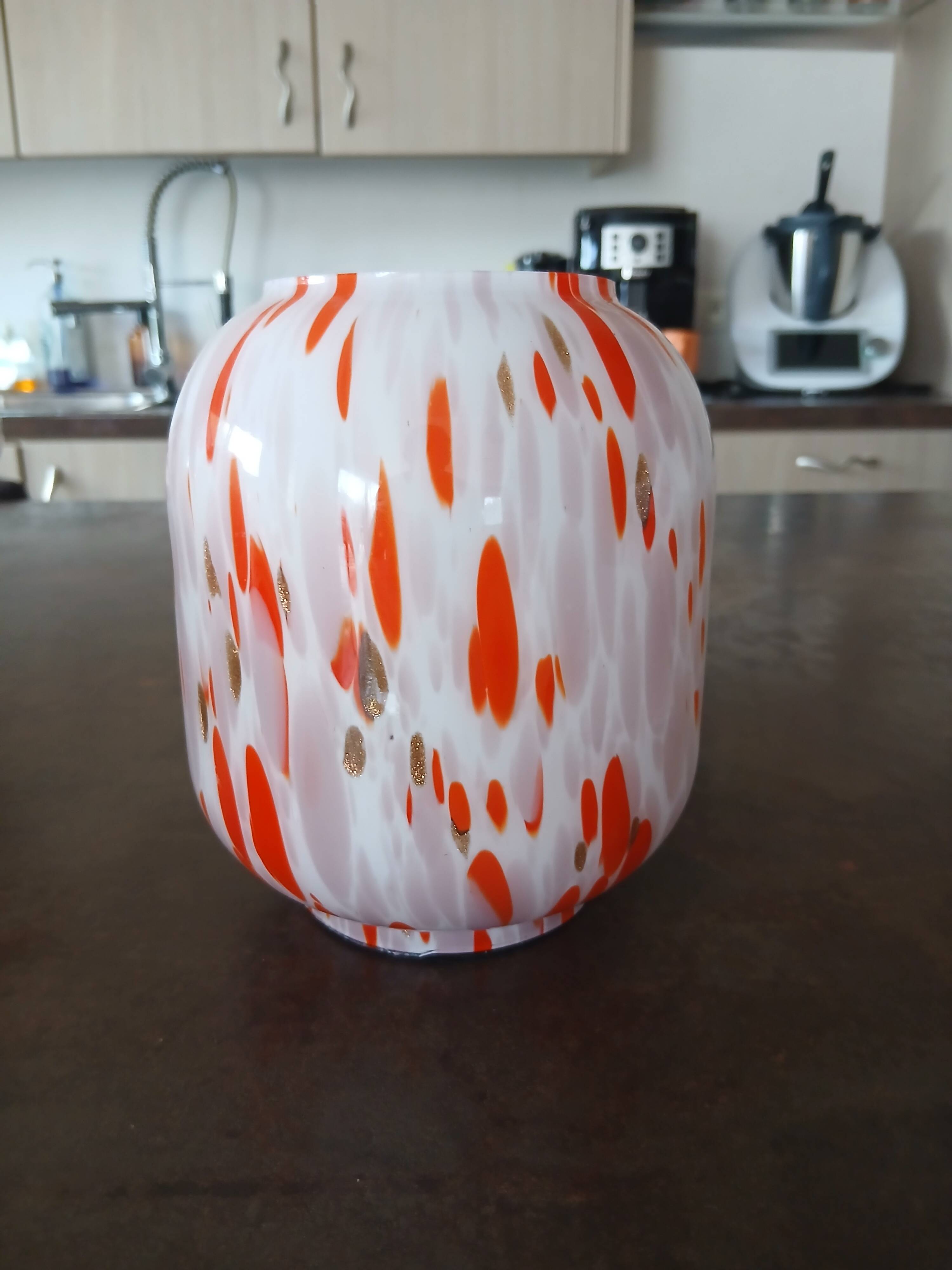 Vintage orange and white glass lamp with golden accents.