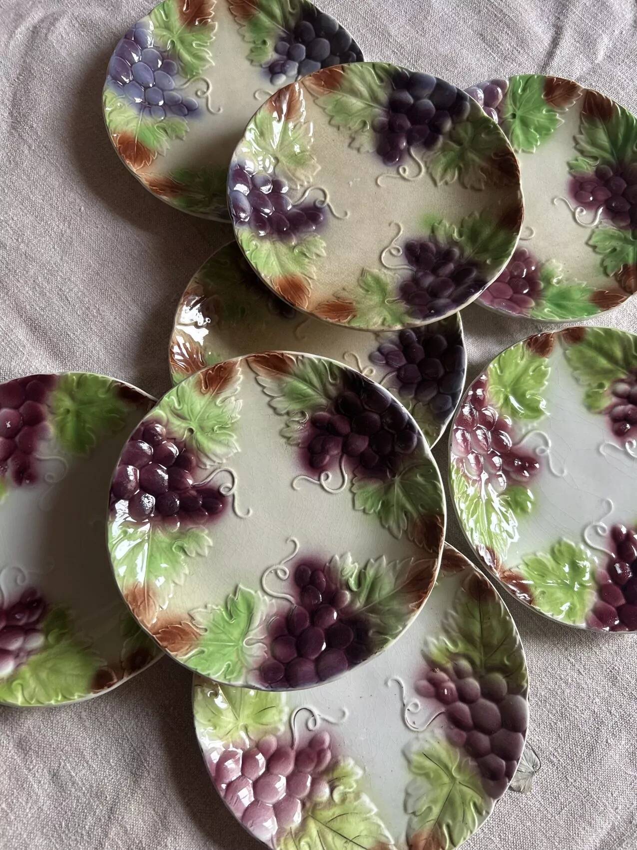 Set of eight flat dessert plates in barbotine earthenware with grape decoration – circa 1900.