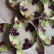 Set of eight flat dessert plates in barbotine earthenware with grape decoration – circa 1900.
