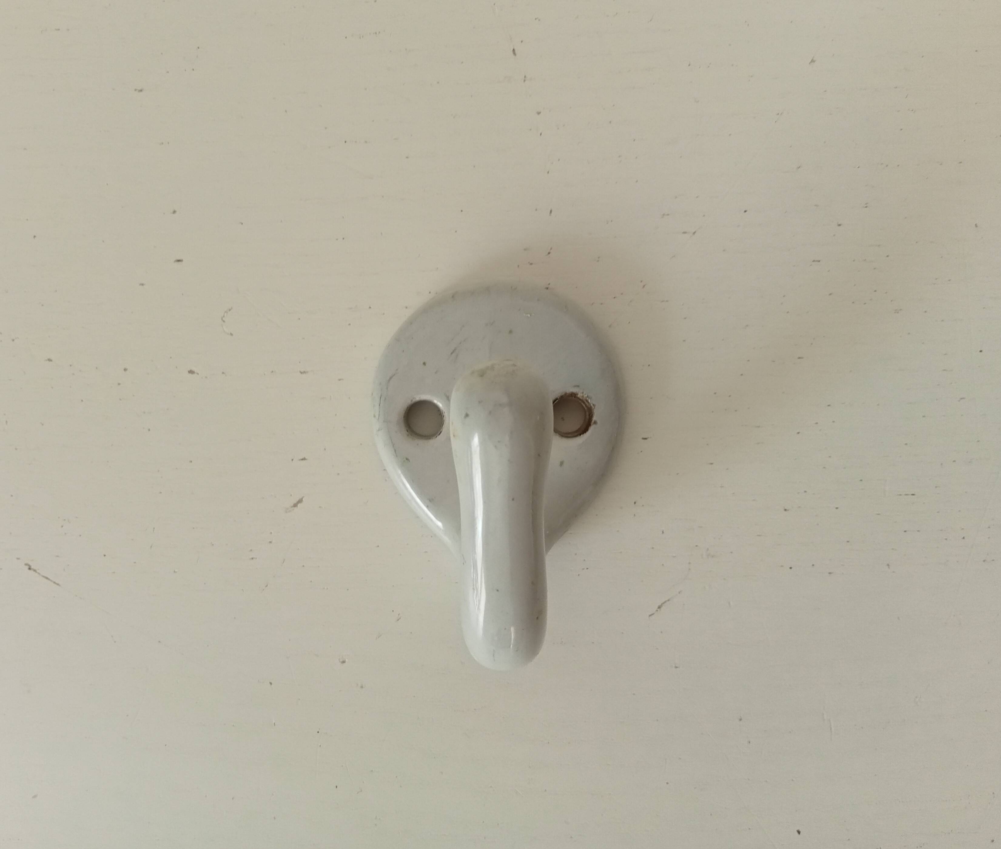 Antique enamelled cast iron wall hook from the 30s/40s