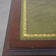 Wooden bookstand with green leather surface and on wheels in English style