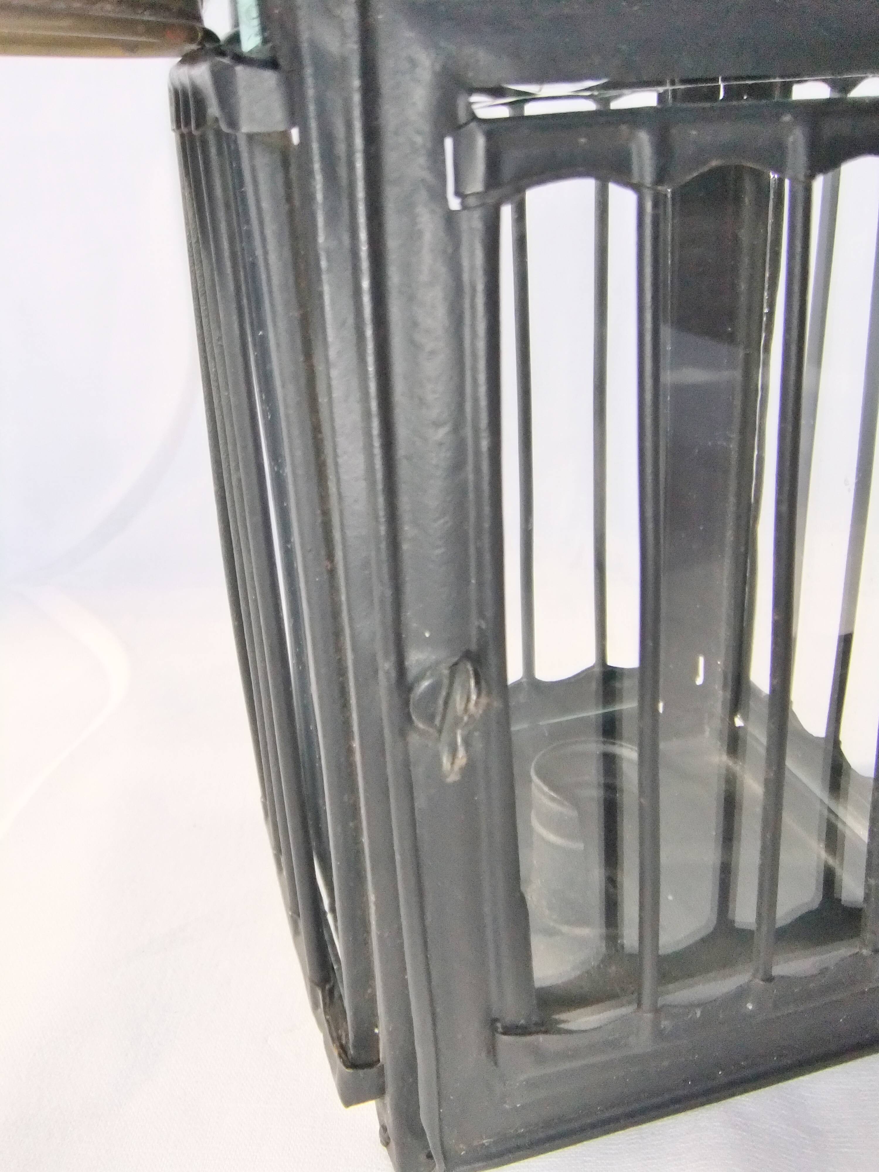 Old chandelier hanging lantern with candle in sheet metal