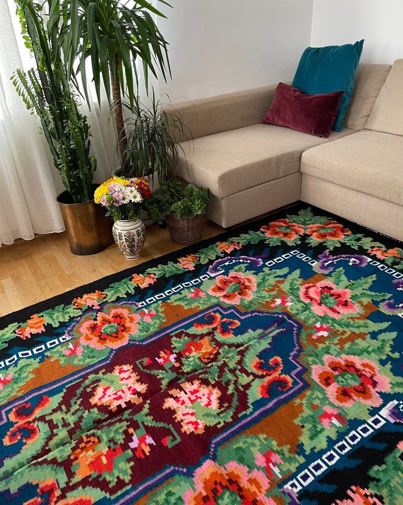 Rug with floral design on a blue background made by hand in Romania