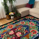Rug with floral design on a blue background made by hand in Romania