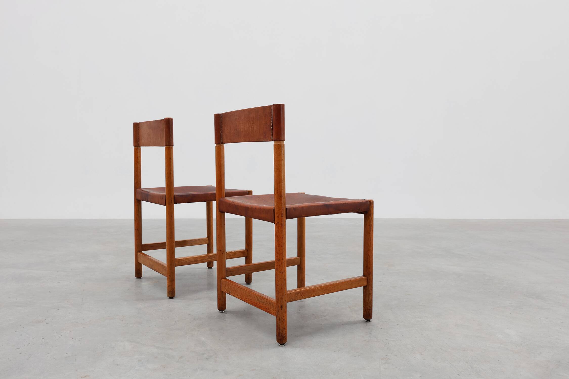 Pair of wood and leather Spanish chairs by Jordi Vilanova, ca. 1960