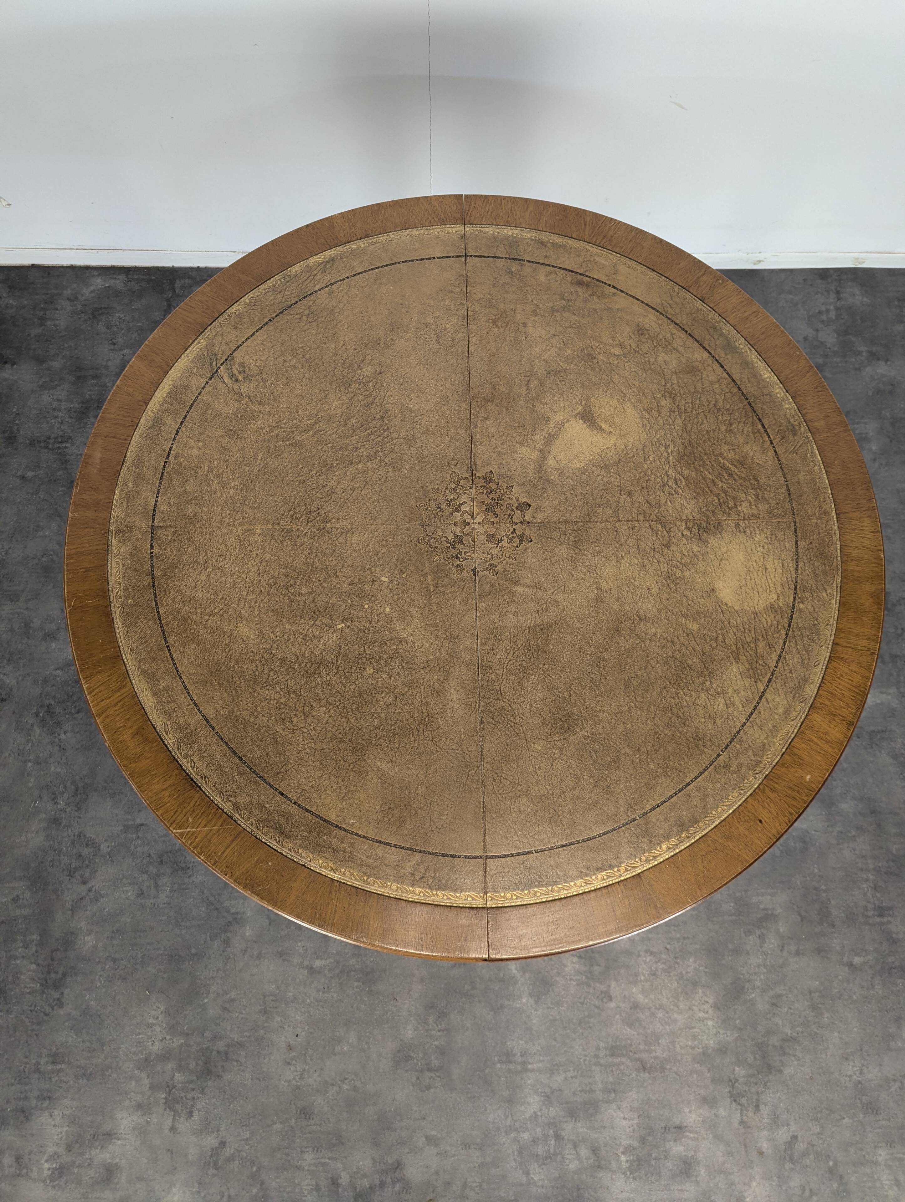 Louis XVI style dining table with a leather top.