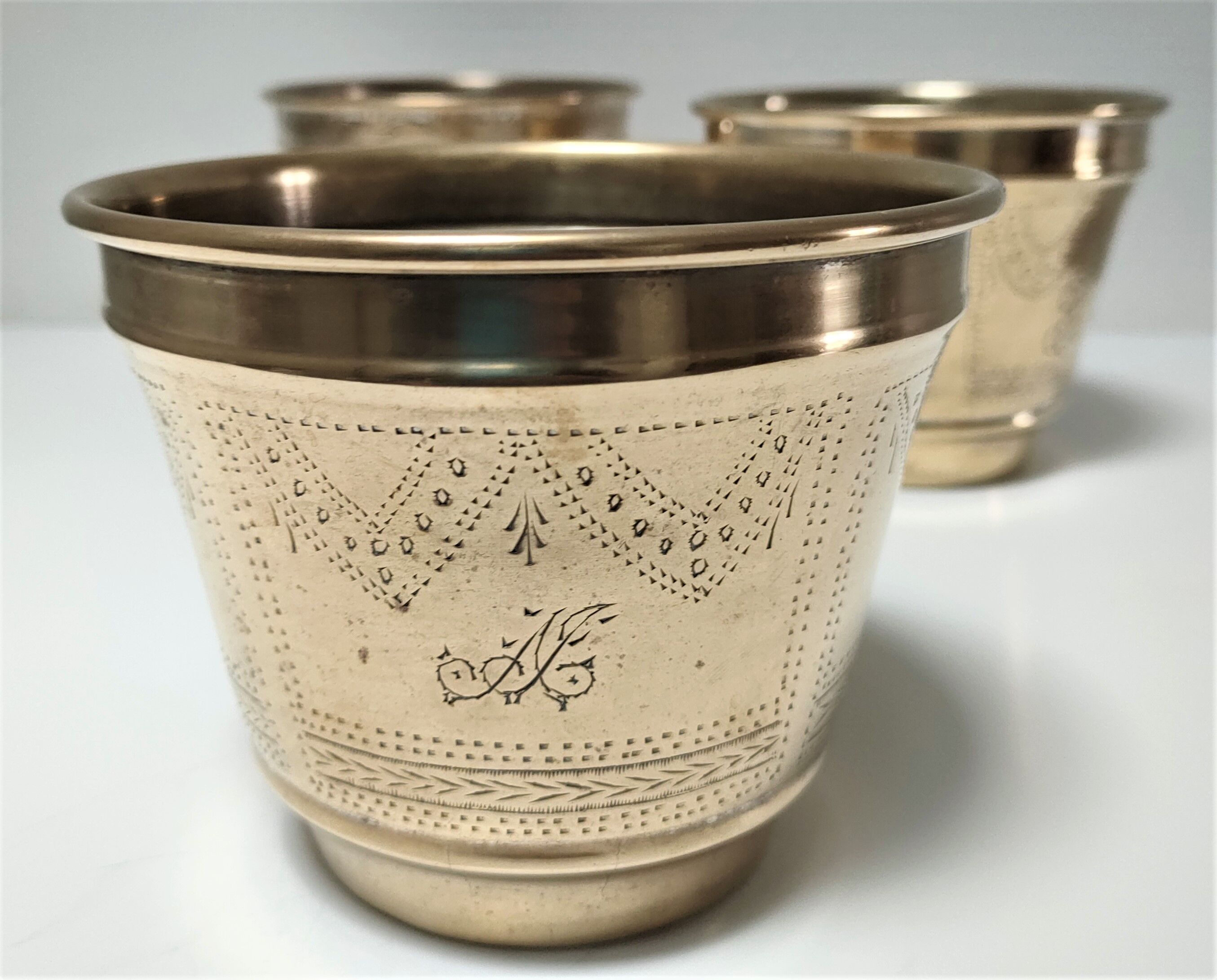 Three pot covers brass silver cover golden patina monogram early twentieth century