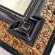 Antique wall mirror in blackened wood and gilded stucco, 19th-century Dutch style.