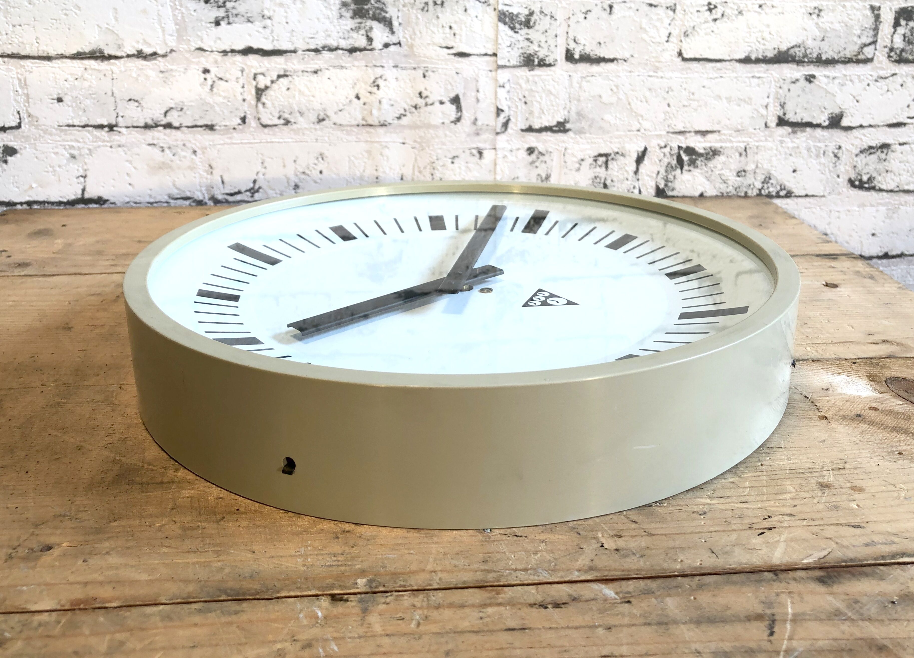 Beige industrial bakelite wall clock from Pragotron, 1970s