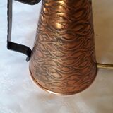 Old watering can in red copper and brass
