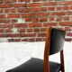 Set of 2 vintage Scandinavian chairs in wood and black faux leather.