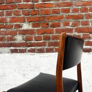 Set of 2 vintage Scandinavian chairs in wood and black faux leather.