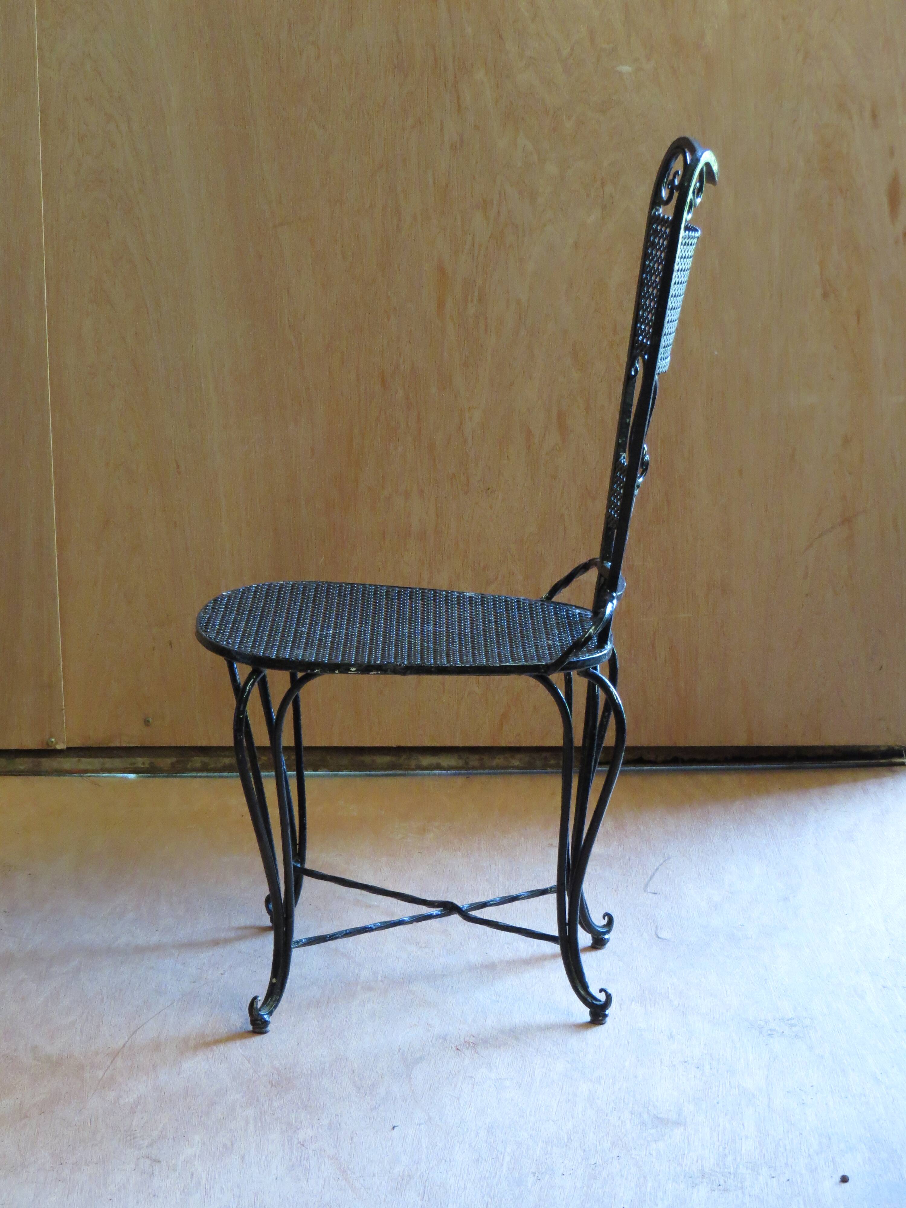 Pair of black lacquered wrought iron garden chairs