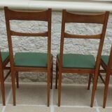 6 modern chairs with banded backs and green faux leather seats