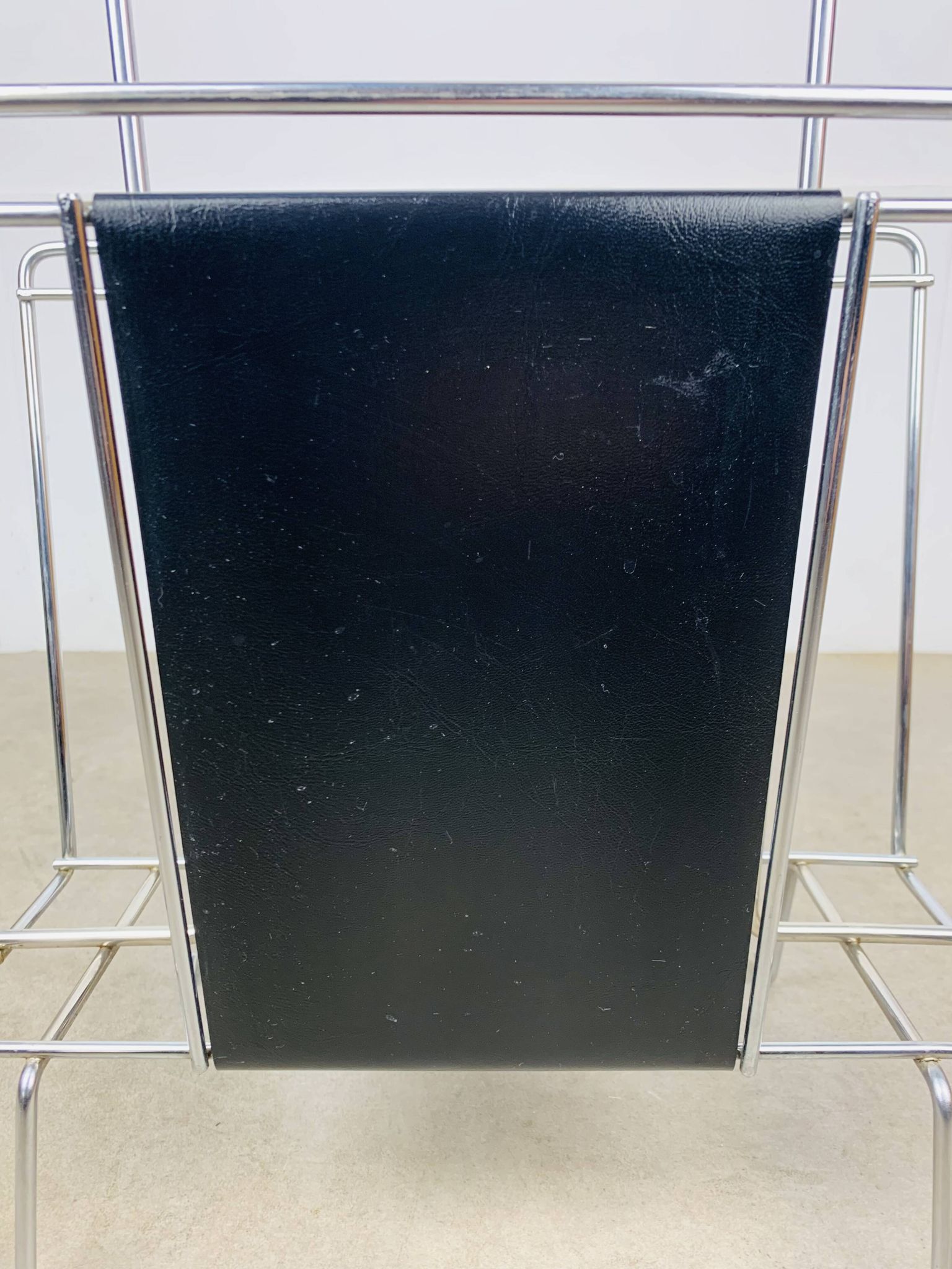 Chrome and black leather magazine rack, 1970s.