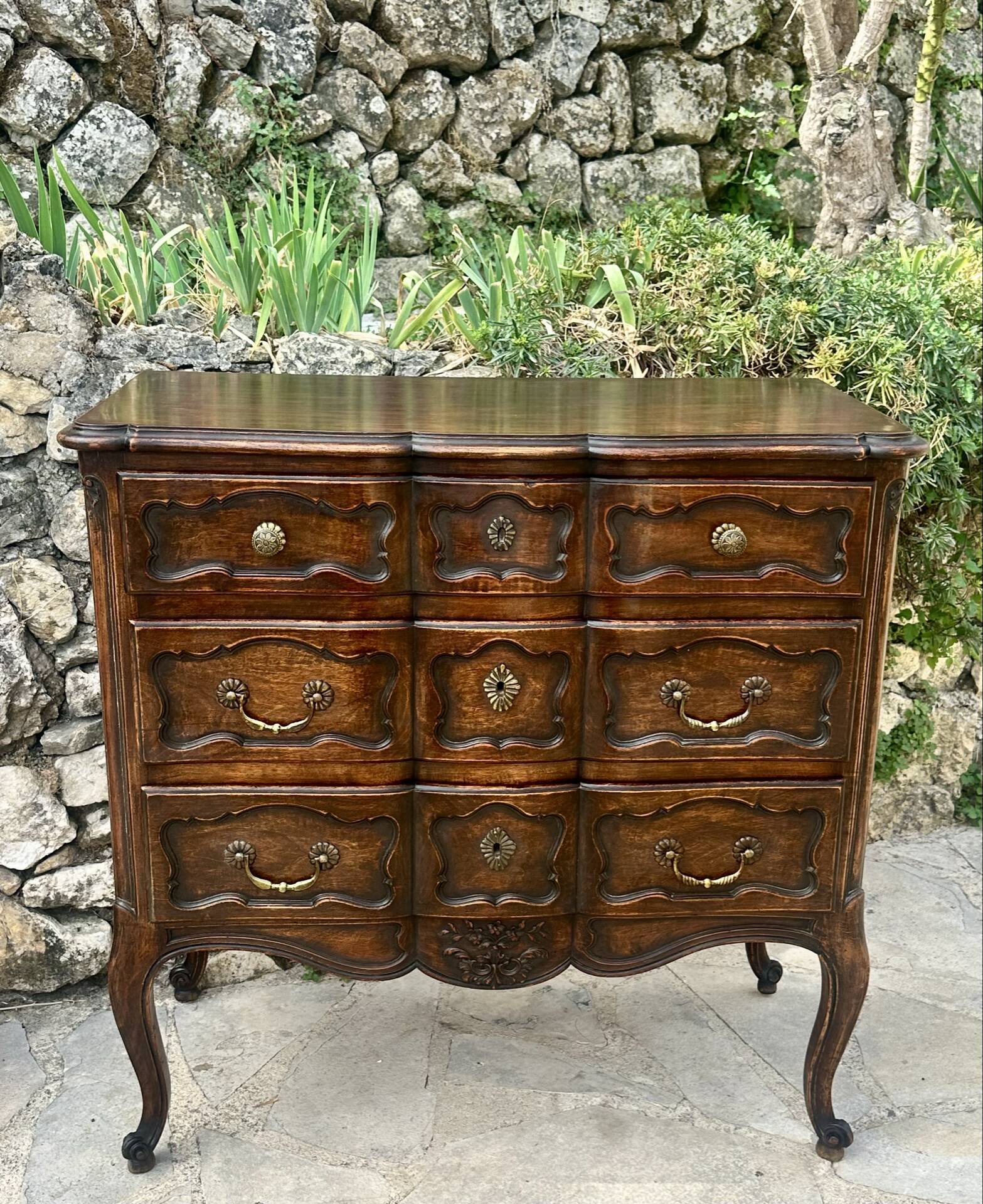 Carved and moulded solid wood commode in the Louis XV style.