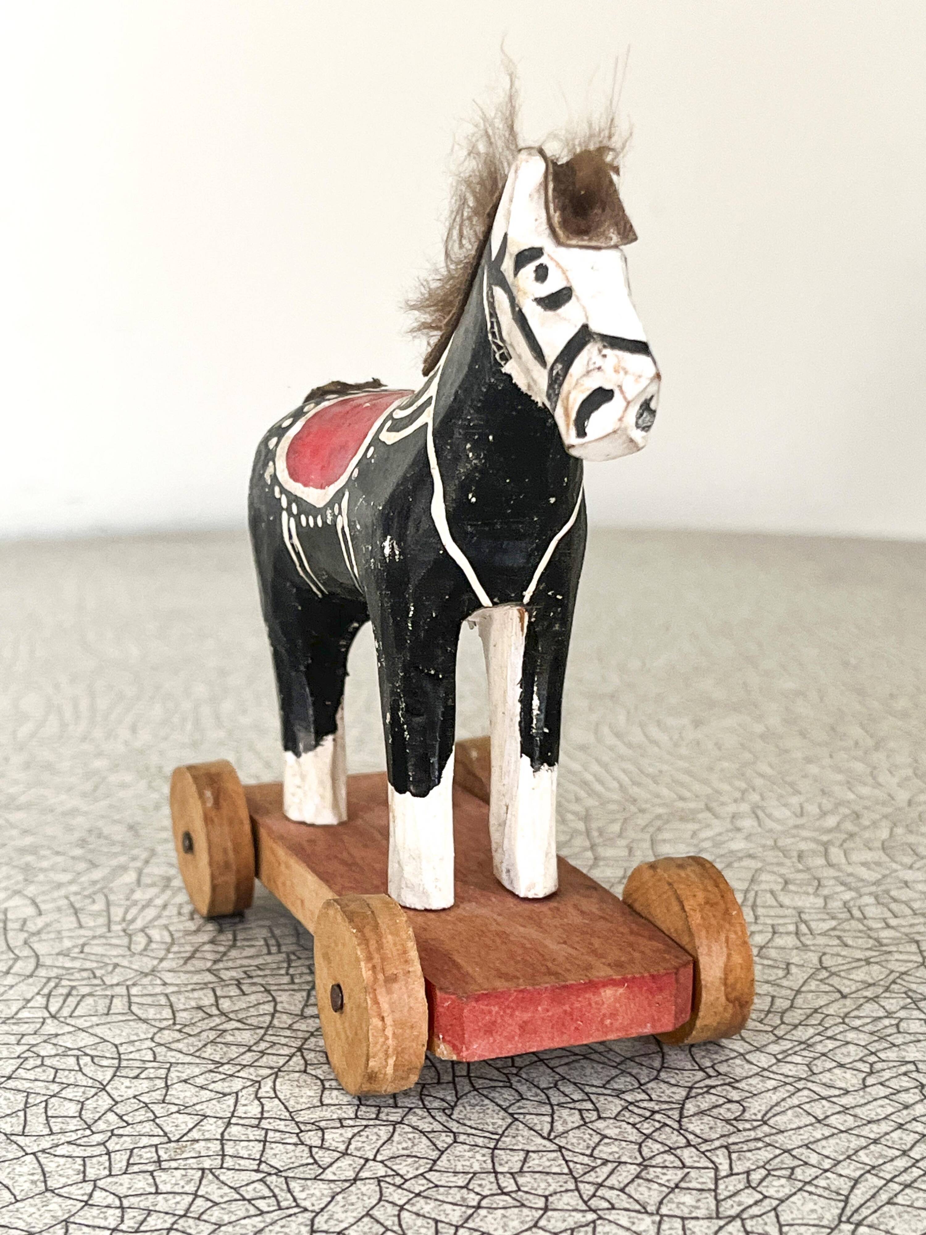 Old wooden pull-along toy, horse.