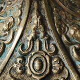 Baroque/Antique style torch candleholder, nineteenth, gilded bronze. Head motifs, volute arabesques