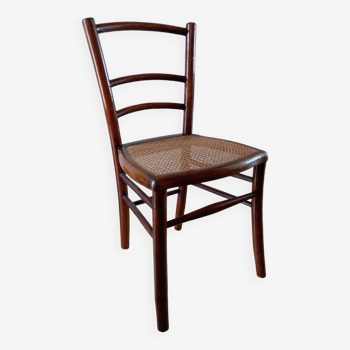 Wooden chair with cane seat, country style, circa 1920