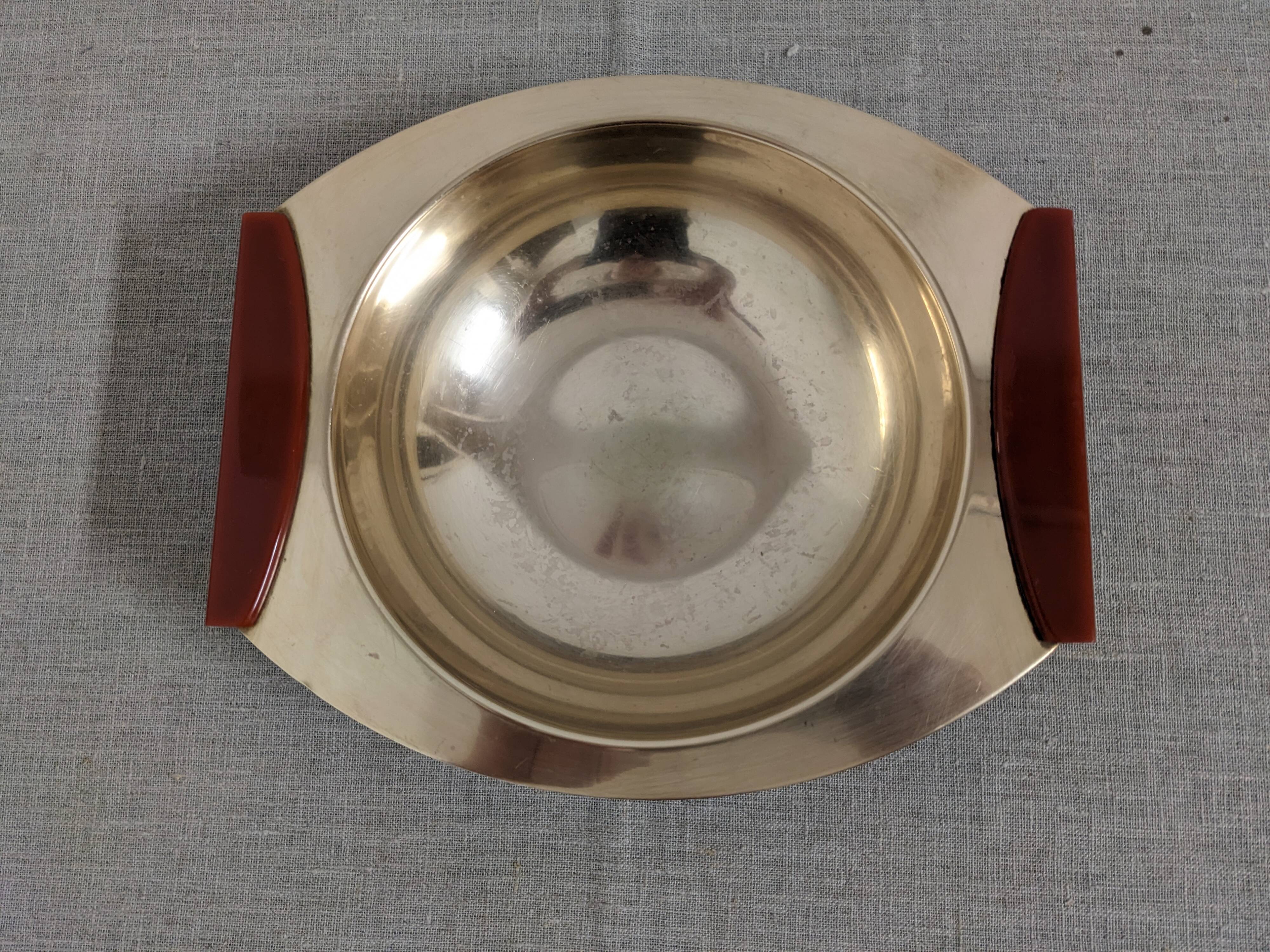 Plates and a brass and Bakelite cut by PM Italy, Italy around 1970.