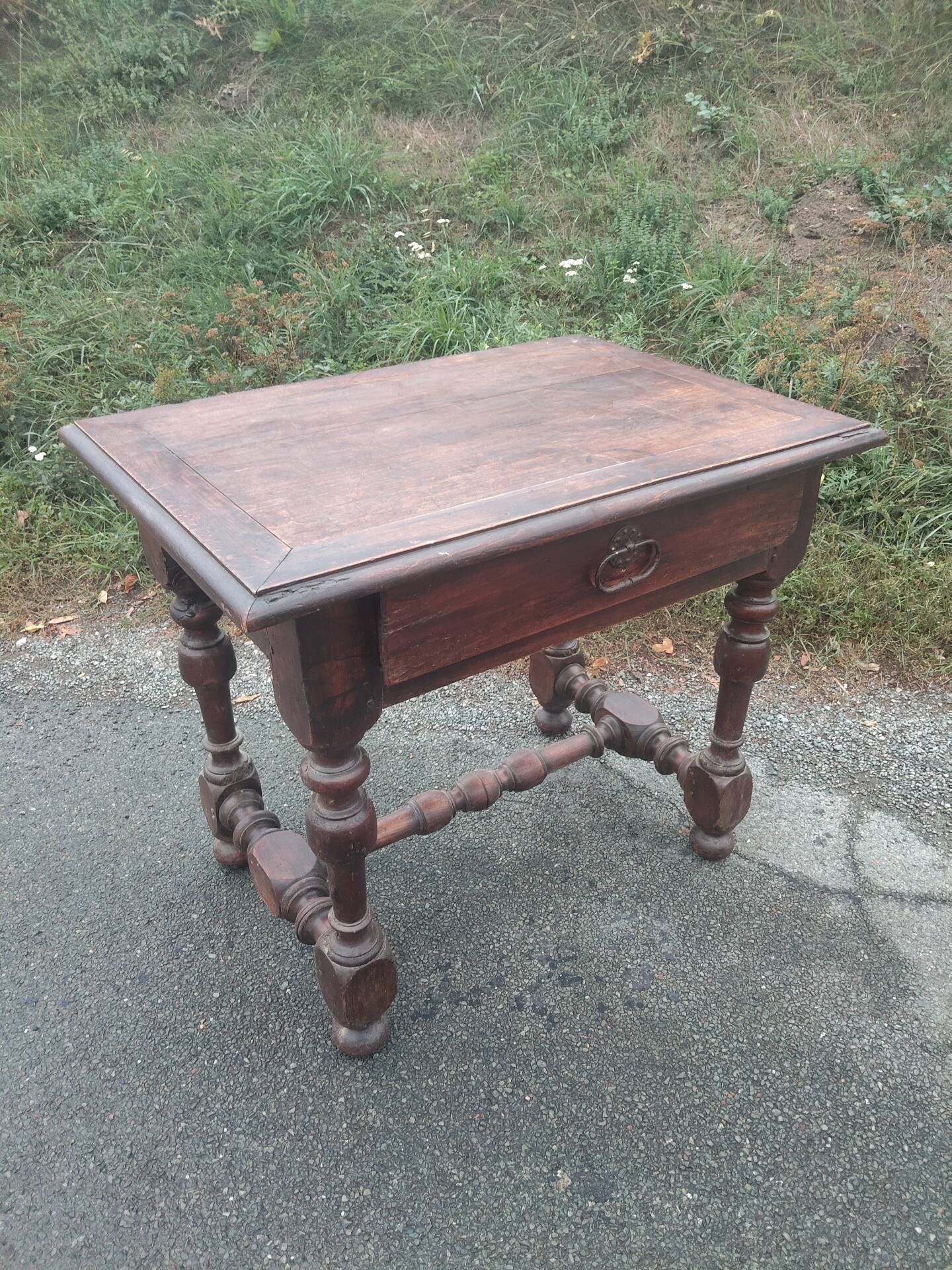 Small antique writing table in Louis XIII style made of oak.