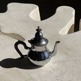 Silver-plated teapot with black handle