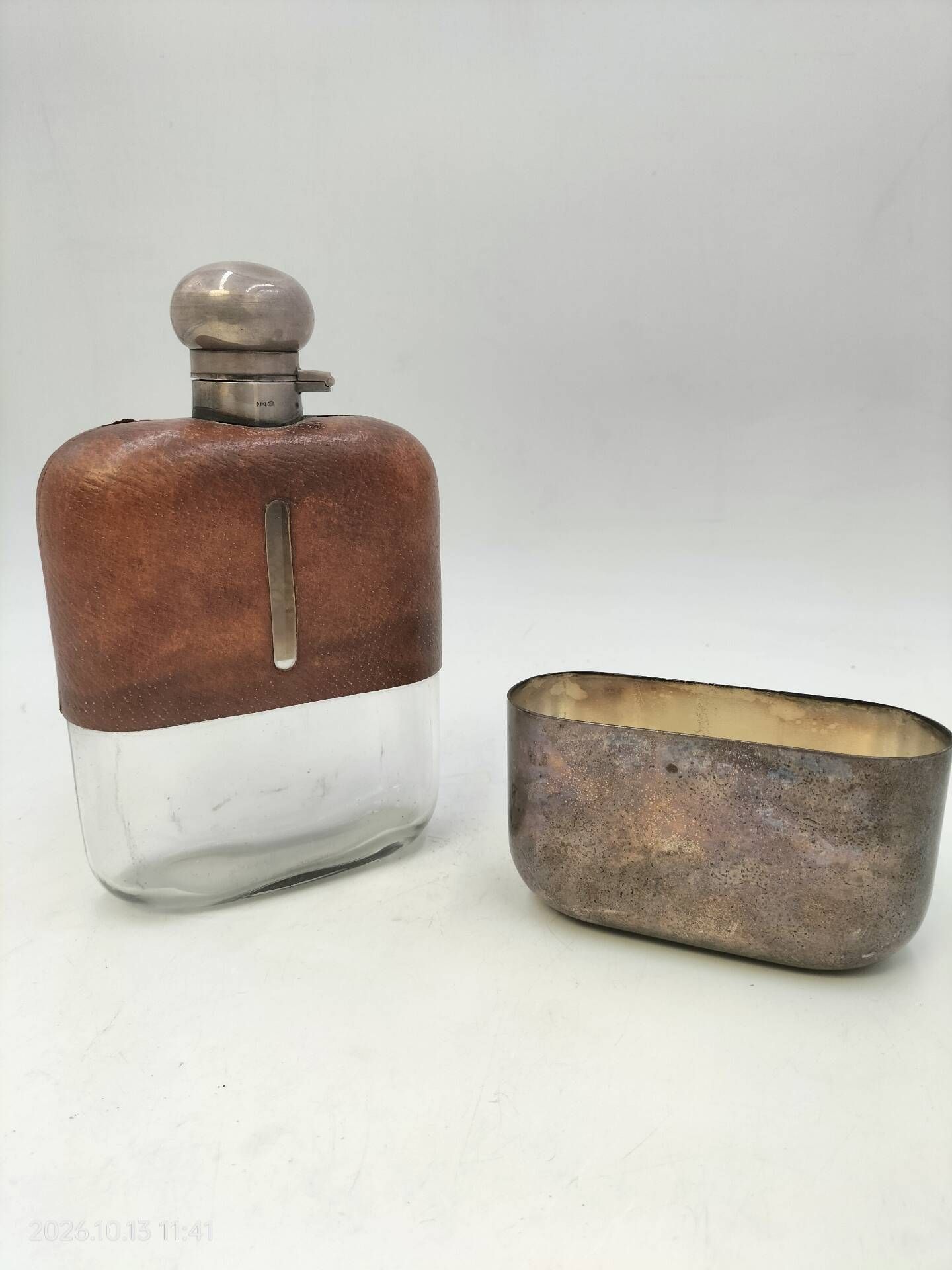 Silver-plated metal flask with leather and glass