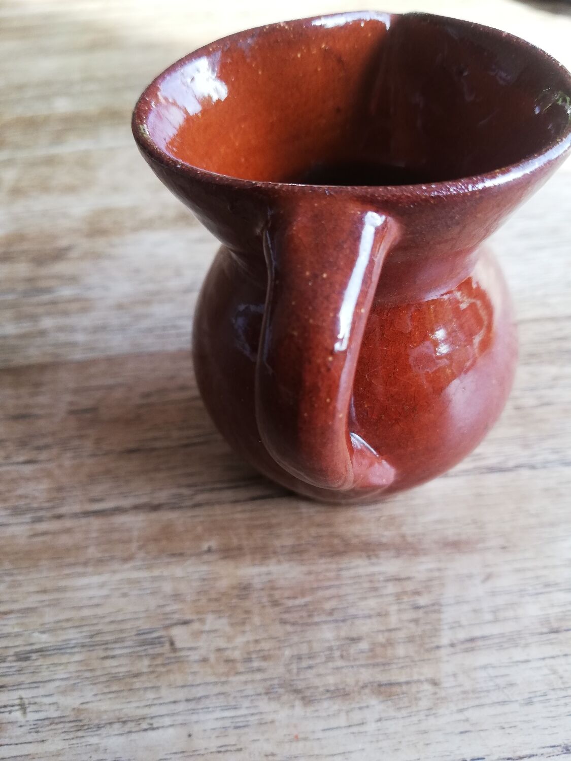 Small two-tone brown-yellow terracotta pitcher