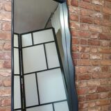 A renovated mirror in a wooden frame with a drawer and a shelf