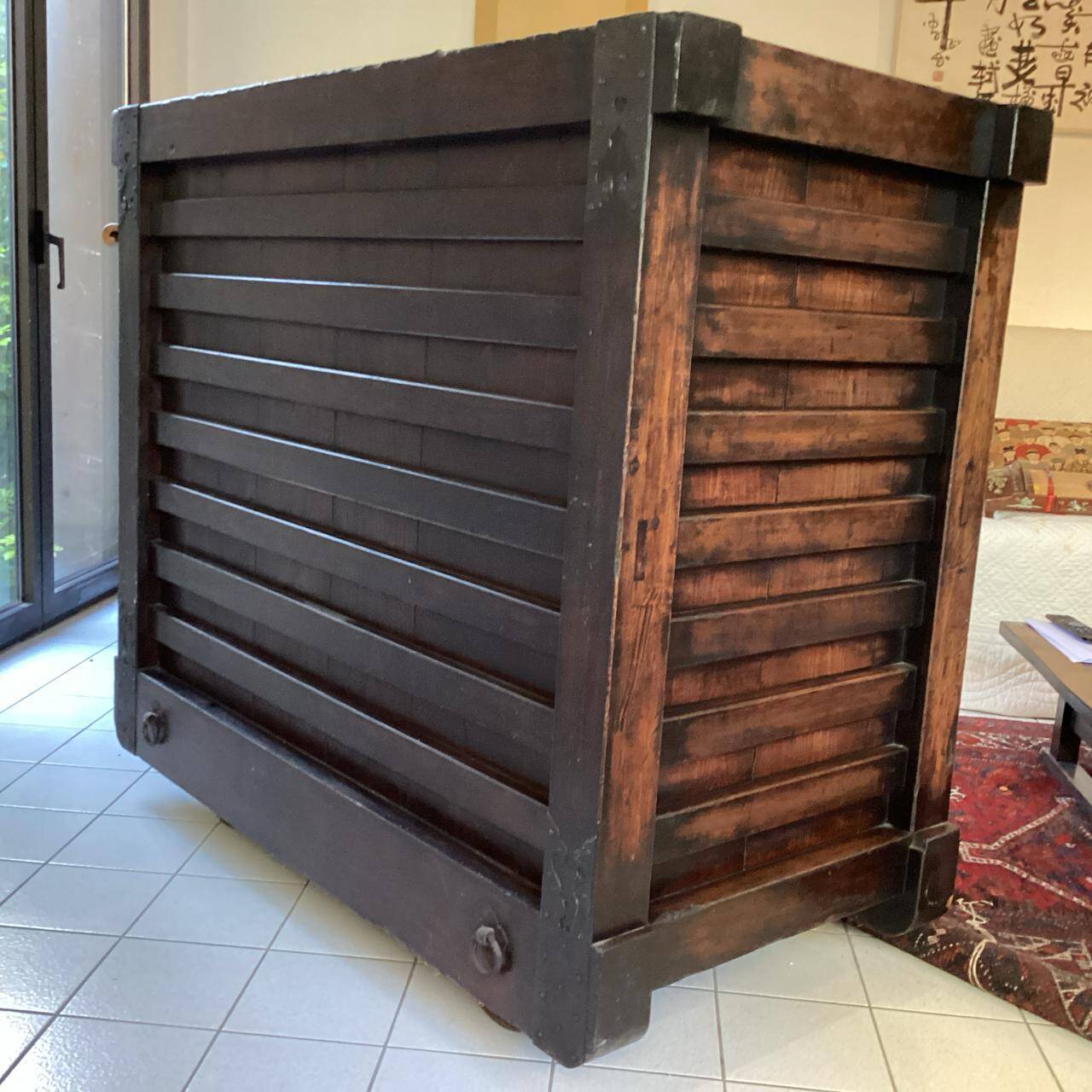 Japanese antique wooden chest with black fittings.