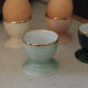Four coloured egg cups with a golden rim from the 50s.