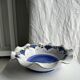 Small hand-painted earthenware salad bowl with garland of blue flowers, mark below