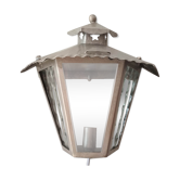 Half grey metal wall sconce and 3 windows
