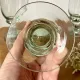 4 stemmed glasses made of handcrafted blown glass in green hue.