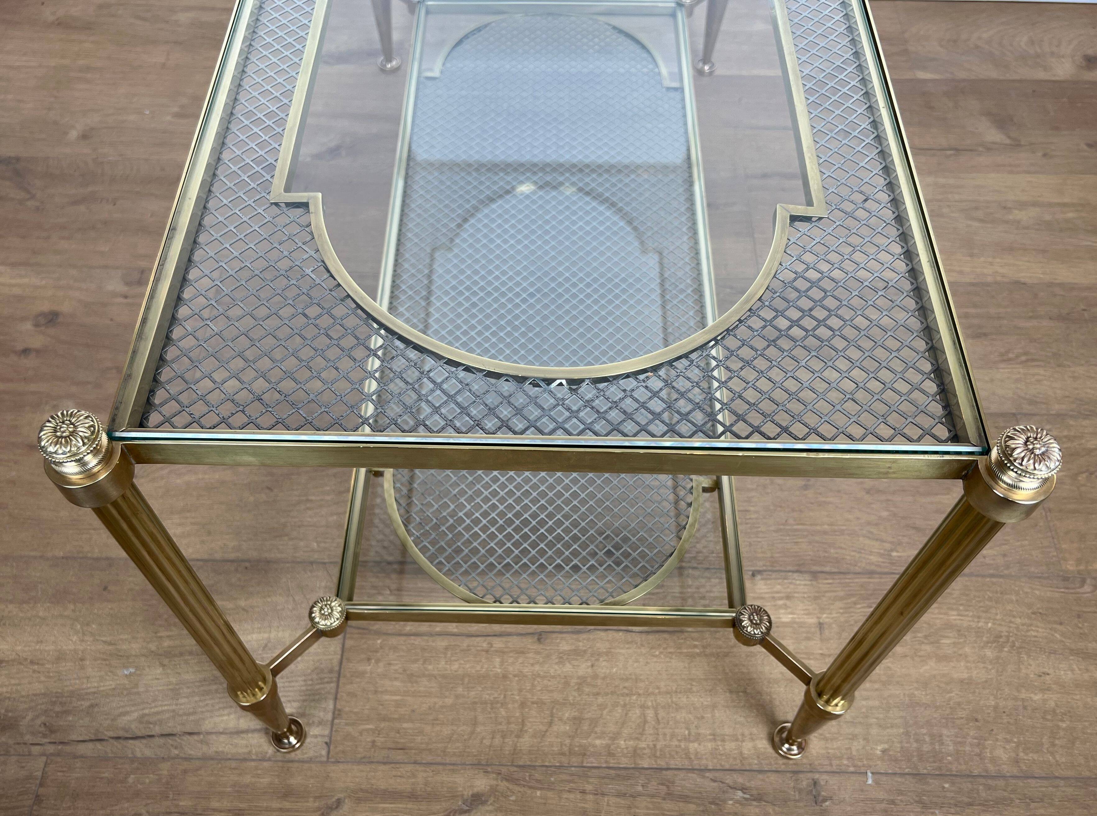 Rare bronze, brass, and steel mesh coffee table with a double glass top resting on a brass mesh. French work by Jansen
