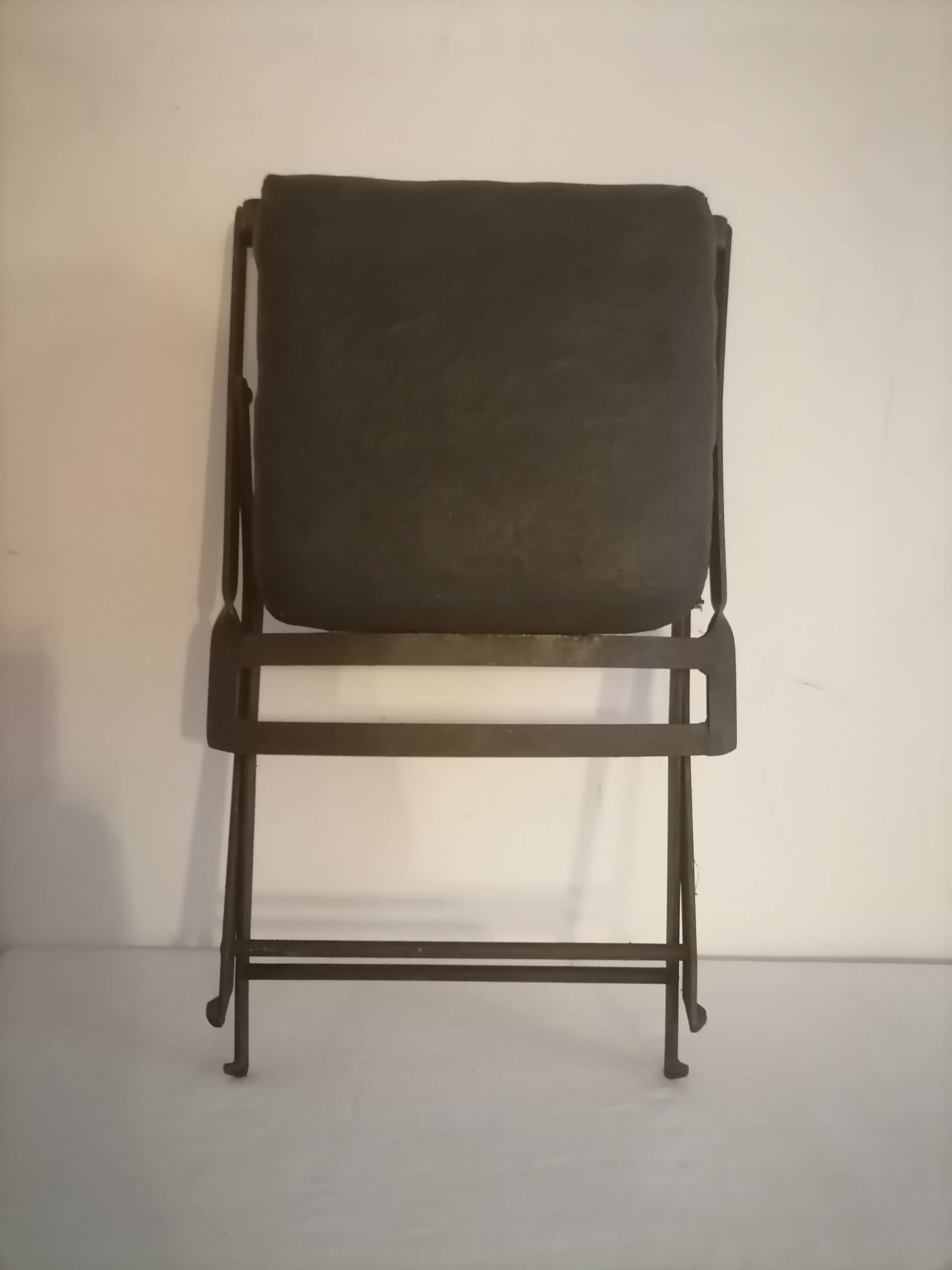 Old wrought iron folding children's chair. Early 20th century.