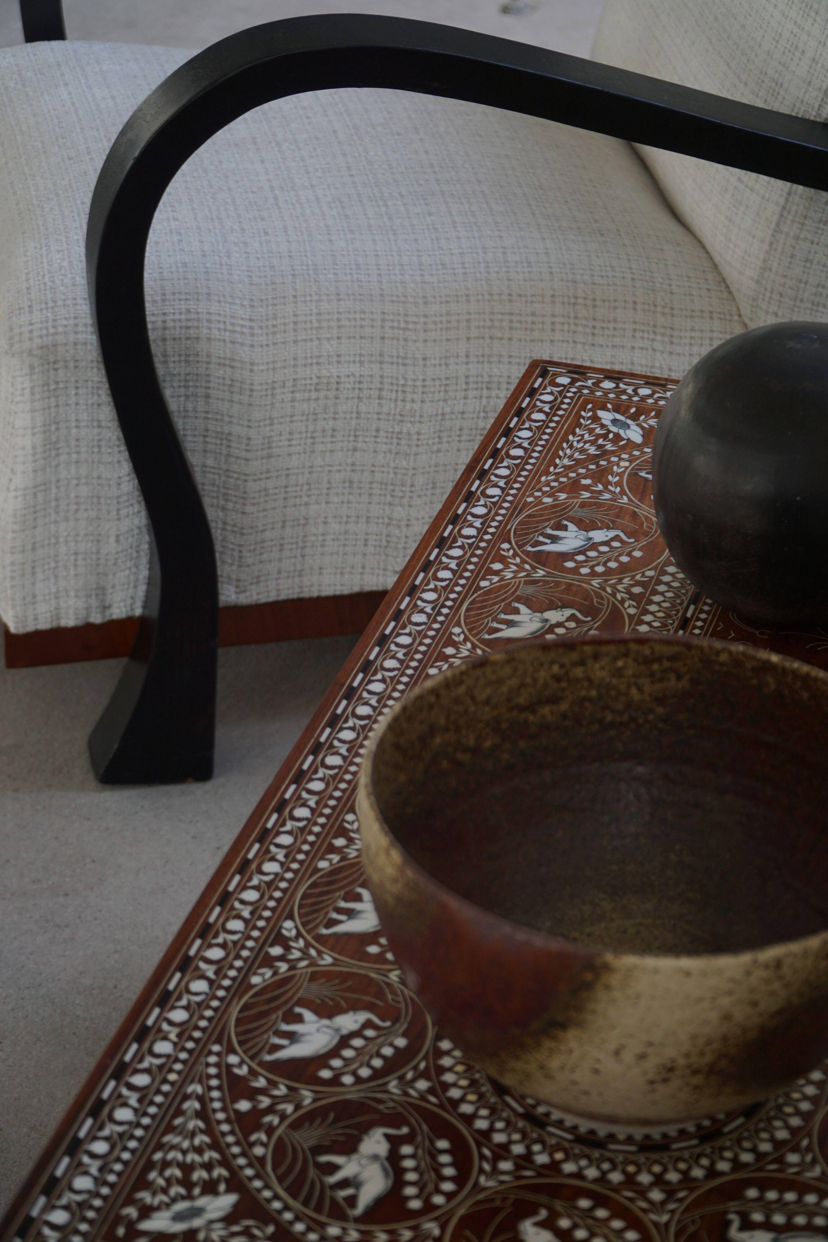 Vintage Indian teak coffee table inlaid with elephant motifs, mid-20th century.