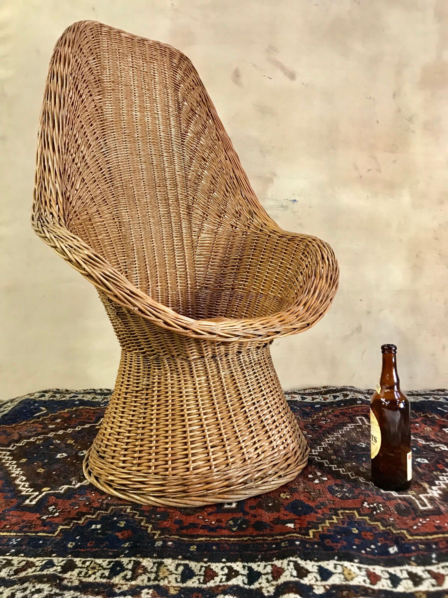 High-backed chair or shepherdess in vintage wicker